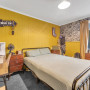 Bedroom painted in Resene Lemon Ginger, ceiling in Black White