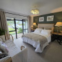 Bedroom with featuring wall in Resene Rivergum, ceiling in White