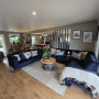 Open plan living area and dining area featuring walls in Resene Half Pravda, ceiling in White