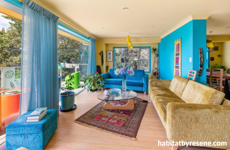 Living room featuring bright blue walls and pale yellow ceiling