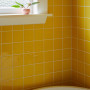 Bathroom featuring yellow tiles and trims painted in Resene Miso