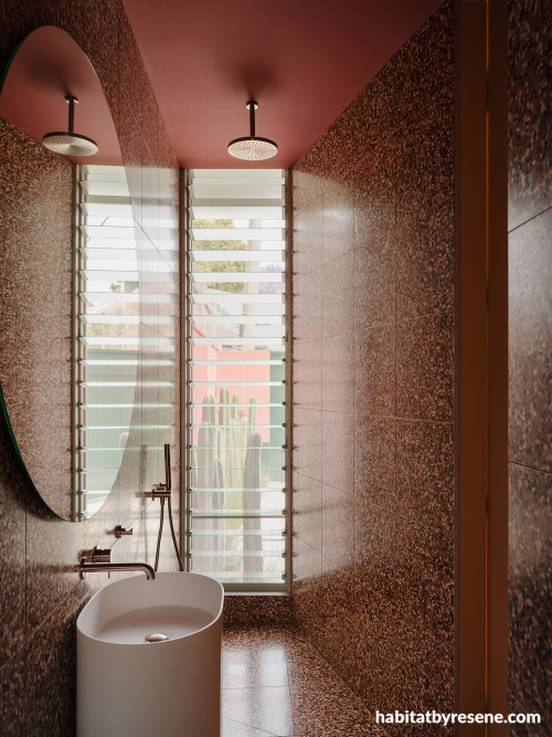 Bathroom with red-toned tiles