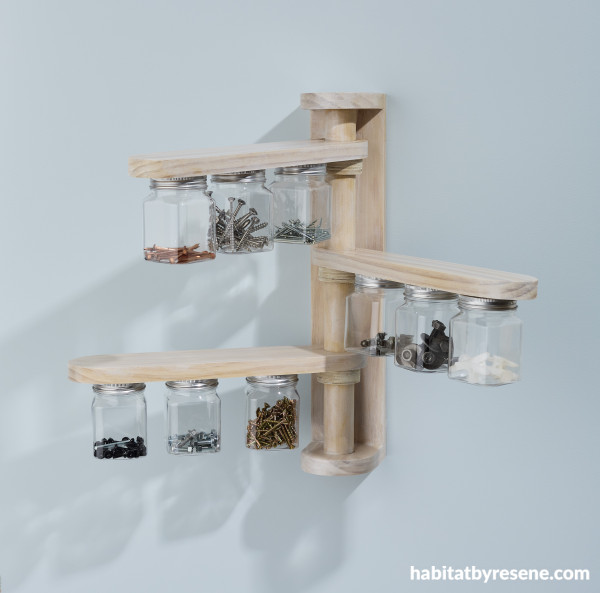 A jar storage project with screws in jars on a blue wall