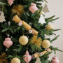 Christmas decorations featuring mustard, white and light pink tones